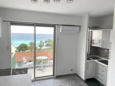 a kitchen with a view of the ocean at STUDIO EN FACE DE LA PLAGE AVEC une VUE FANTASTIQUE ! in Nice