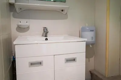 a bathroom with a white sink and a soap dispenser at Alpazur in Nice