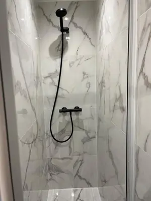 a bathroom with a shower with a glass door at Nice Cosy in Nice