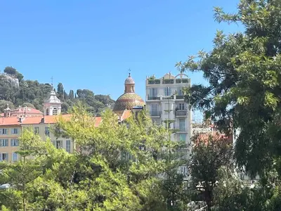 a tall white building with a dome on top of it at Beautiful studio with parking place Massena in Nice