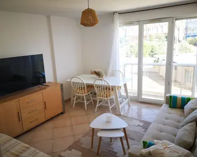 a living room with a couch and a table at Appartement cosy sur la French Riviera I Climatisation I 2 minutes des plages in Nice