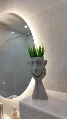 a vase with a plant in it sitting on a counter at Appartement cosy sur la French Riviera I Climatisation I 2 minutes des plages in Nice