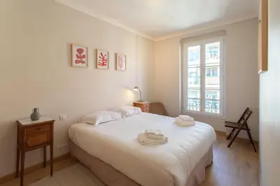 a white bedroom with a bed and a window at #25 2BDR Port, 5min from the Old Town Balcony, AC&WIFI in Nice