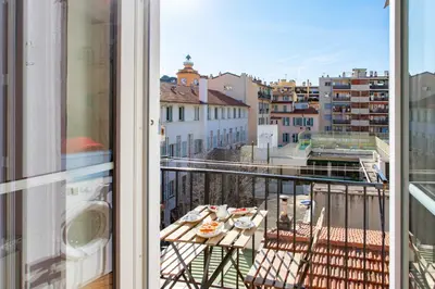 a balcony with a table and a view of a city at #25 2BDR Port, 5min from the Old Town Balcony, AC&WIFI in Nice