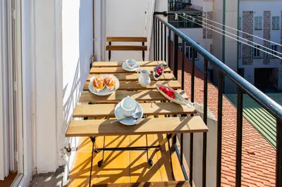 a table on a balcony with food on it at #25 2BDR Port, 5min from the Old Town Balcony, AC&WIFI in Nice