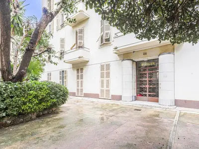 a large white building with a tree in front of it at Apartment Le Mirazur by Interhome in Nice