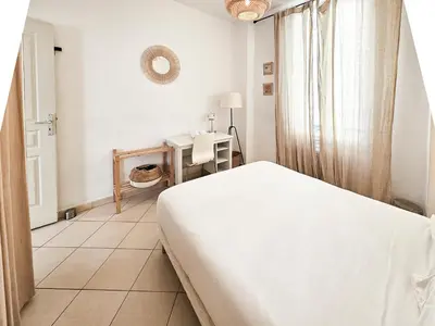 a white bedroom with a bed and a window at Fontaine 4 Pers AC WiFi in Nice
