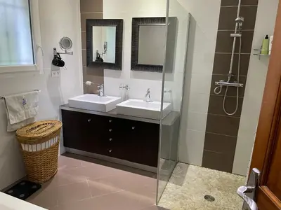 a bathroom with two sinks and a shower at Beautiful villa Nice in Nice