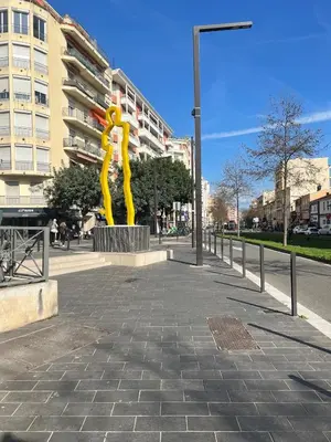 a yellow sculpture on a sidewalk next to a building at Studio élégant avec balcon près de la plage à Nice in Nice