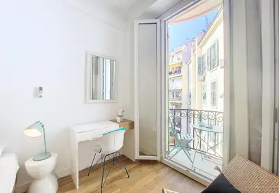 a white room with a desk and a balcony at Nestor&Jeeves - COCOA BEACH - Central - Near Beach in Nice