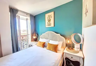 a bedroom with a bed with a mirror and a window at Nestor&Jeeves - CHAISE BLEUE - Central - Near Beach in Nice