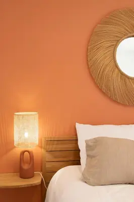 a bedroom with an orange wall with a bed and a lamp at #41 Flat for 6, 3 Bdrs Parking Wifi 5mins walk Tram T1 in Nice