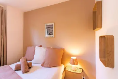 a small bedroom with a bed and a lamp at #41 Flat for 6, 3 Bdrs Parking Wifi 5mins walk Tram T1 in Nice