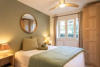 a bedroom with a bed with a ceiling fan and a mirror at #41 Flat for 6, 3 Bdrs Parking Wifi 5mins walk Tram T1 in Nice