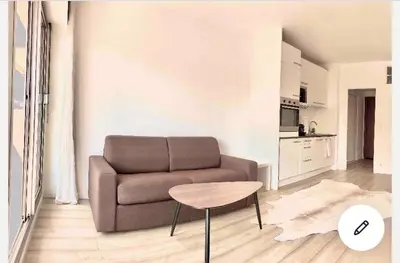 a living room with a couch and a table at Studio Nice clim wifi in Nice