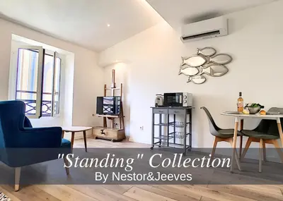 a living room with a table and chairs and a tv at Nestor&Jeeves - COZY CLOUD - Central - Near Beach in Nice