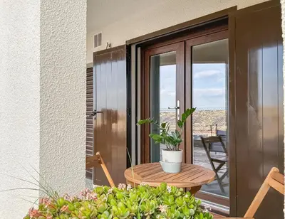 a table with a potted plant on a balcony at Appartement spacieux & vue imprenable in Saint-Laurent-du-Var