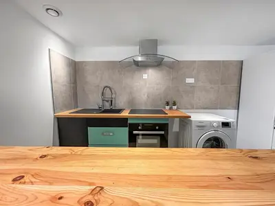 a kitchen with a sink and a stove at Appartement spacieux & vue imprenable in Saint-Laurent-du-Var