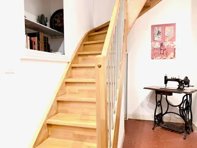 a wooden staircase in a home with a table at E OP Duplex d Antoine Old Port - Old Town in Nice