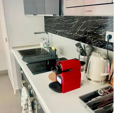 a kitchen counter with a sink and a red appliance at Suite Massena in Nice