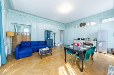 a living room with a blue couch and a table at Villa Monique-Parking free in Nice