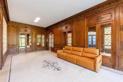 a living room with a couch and wooden walls at Villa Monique-Parking free in Nice