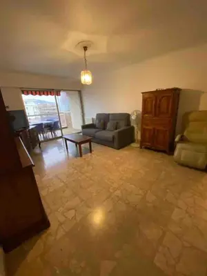 a living room with a couch and a table at T2 Proche plage - Centre cagnes sur mer in Cagnes-sur-Mer