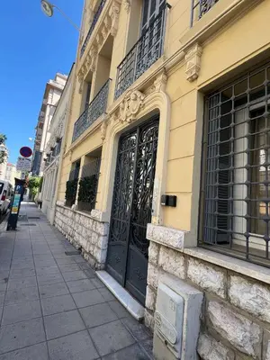 a building with a black door on a street at Coquette studio YourHostelper in Nice