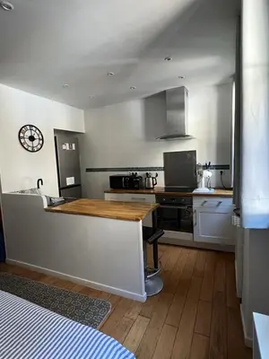 a kitchen with a wooden counter top in a room at Coquette studio YourHostelper in Nice