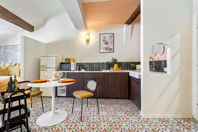 a kitchen with a table and some chairs in a room at Nice Renting - CENTRALE - Authentic Loft Old Nice Rooftop View & Charm in Nice