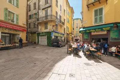 a group of people sitting at tables on a city street at Nice Renting - CENTRALE - Authentic Loft Old Nice Rooftop View & Charm in Nice