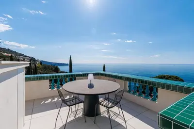 a table and chairs on a balcony with the ocean at New - sea view - splendid apartment in Nice