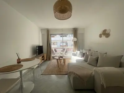 a living room with a couch and a table at apppartement avec terrasse - 2 à 4 personnes in Nice