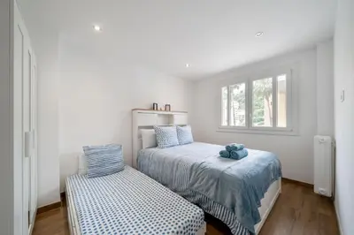 a bedroom with two beds and a window at Modern apartment, steps from tramway in Nice