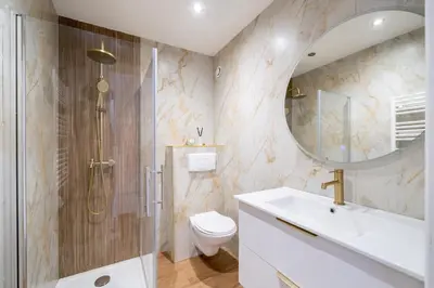 a bathroom with a shower and a toilet and a sink at Modern apartment, steps from tramway in Nice