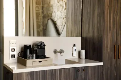 a kitchen counter with a sink and a mirror at Notre Dame Hotel - Self Check-in in Nice
