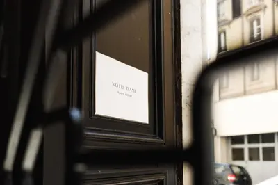 a window of a building with a sign on it at Notre Dame Hotel - Self Check-in in Nice