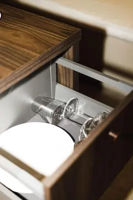 a bathroom sink in a wooden cabinet with a mirror at Notre Dame Hotel - Self Check-in in Nice