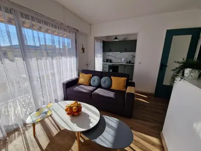 a living room with a couch and a table at Chez Stella - Proche Mer in Nice