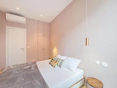a bedroom with a bed and a white wall at Nestor&Jeeves - PEPYTE - Design - Near Beach in Nice
