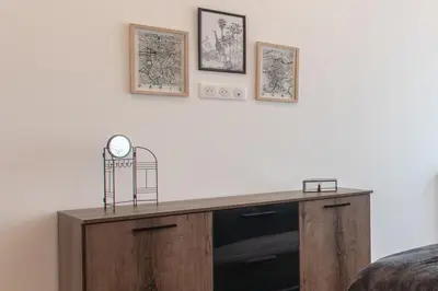 a wooden desk with a clock on a wall at L38 Hobeika Suite Fleur 7min Walk To Beach,Free Park,Balc&AC in Nice