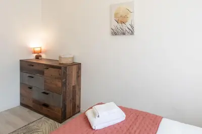 a bedroom with a bed and a dresser with a picture at L38 Hobeika Suite Fleur 7min Walk To Beach,Free Park,Balc&AC in Nice