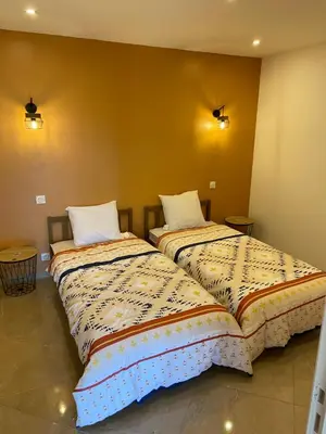 two beds sitting next to each other in a room at Appartement T3 dans une villa au calme in Drap