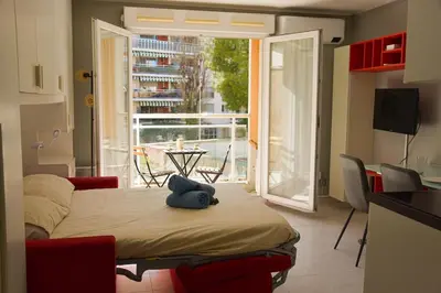 a room with a bed with a blue stuffed animal on it at Studio avec terrasse à Nice in Nice