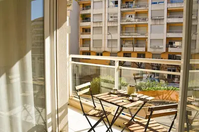 a balcony with a table and chairs and a building at Studio avec terrasse à Nice in Nice