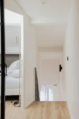 a white room with a bed and a wooden floor at Modern 3BR Duplex Near Nice Port & Old Town | By Airnest in Nice