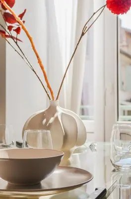 a white vase sitting on a table with a bowl at Modern 3BR Duplex Near Nice Port & Old Town | By Airnest in Nice