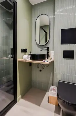 a bathroom with a sink and a toilet and a mirror at Fancy 3BR Duplex Near Nice Port & Old Town | By Airnest in Nice