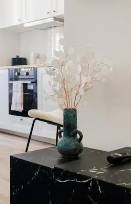 a vase sitting on top of a table in a kitchen at Fancy 3BR Duplex Near Nice Port & Old Town | By Airnest in Nice