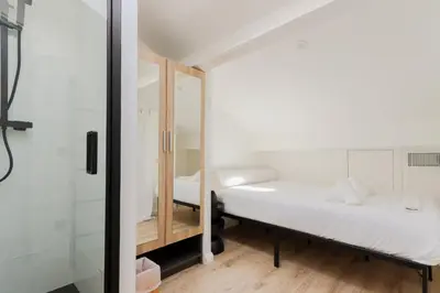 two beds in a room with a shower at Fancy 3BR Duplex Near Nice Port & Old Town | By Airnest in Nice